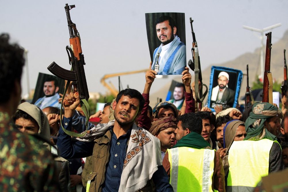 Supporters of Yemen's Houthi rebels raise portraits of their leader Abdul Malik Al-Houthi during a rally in the capital Sanaa on June 3, 2022.