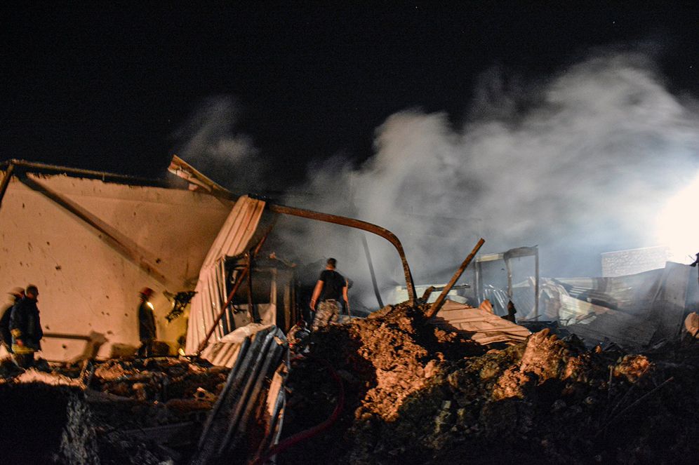 People inspect damage after an Israeli missile strike in the coastal province of Latakia, Syria, on May 5, 2021.