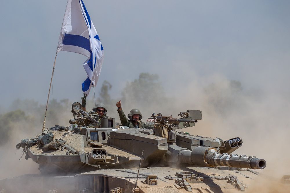 Israeli Merkava tanks pull back from the Gaza Strip near the border with Israel.