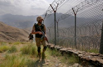 Pakistan Army troops patrol along the fence on the Pakistan Afghanistan border at Big Ben hilltop post in Khyber district, Pakistan.
