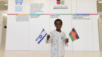 Miracle waves the Israeli and Malawian flags in the lobby of the Sylvan Adams Children’s Hospital 