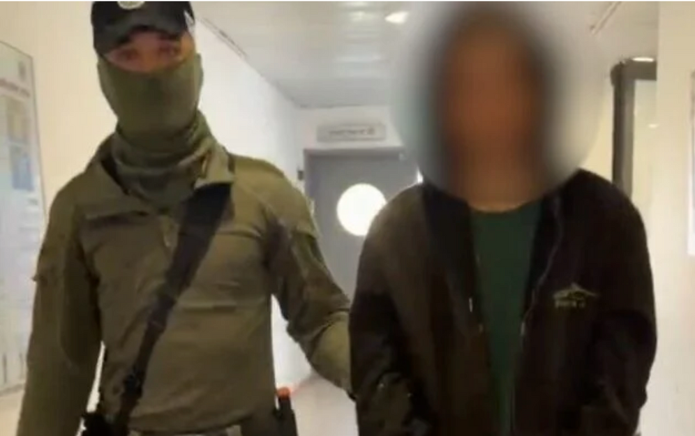 A teenage settler arrested for beating a dog in the West Bank village of Atara being brought into the police station on June 3, 2026.
