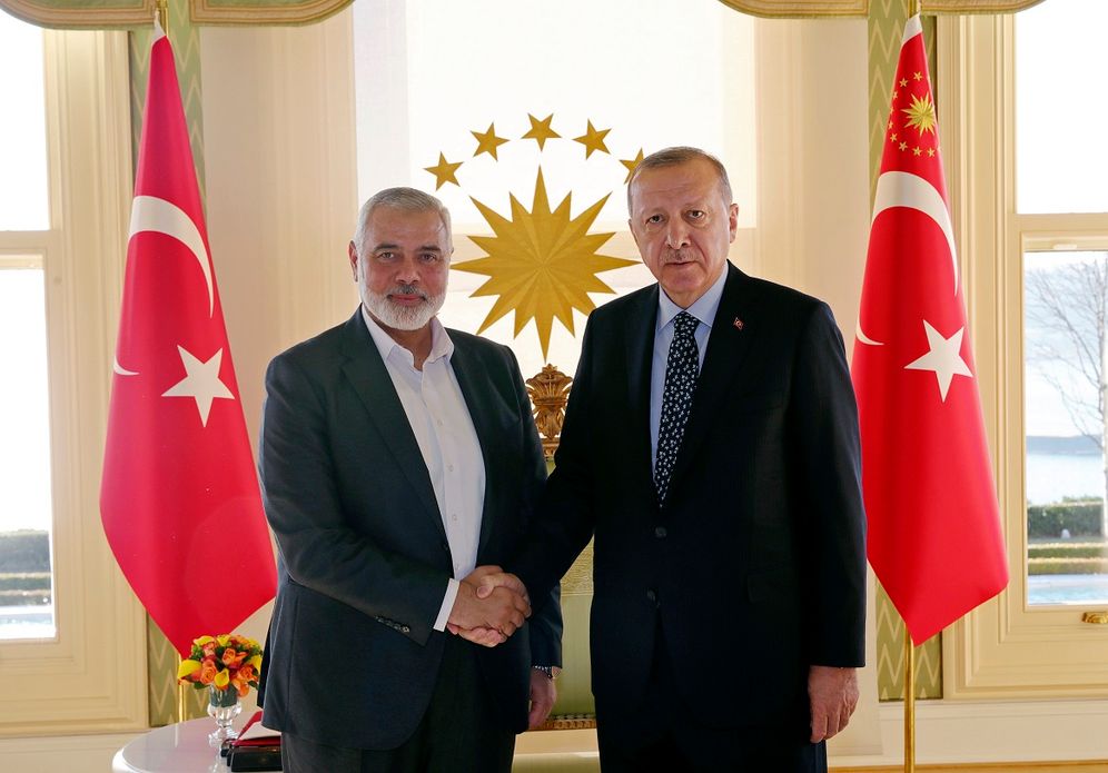 FILE - Turkey's President Recep Tayyip Erdogan, right, shakes hands with Hamas movement chief Ismail Haniyeh, prior to their meeting in Istanbul, on February 1, 2020.
