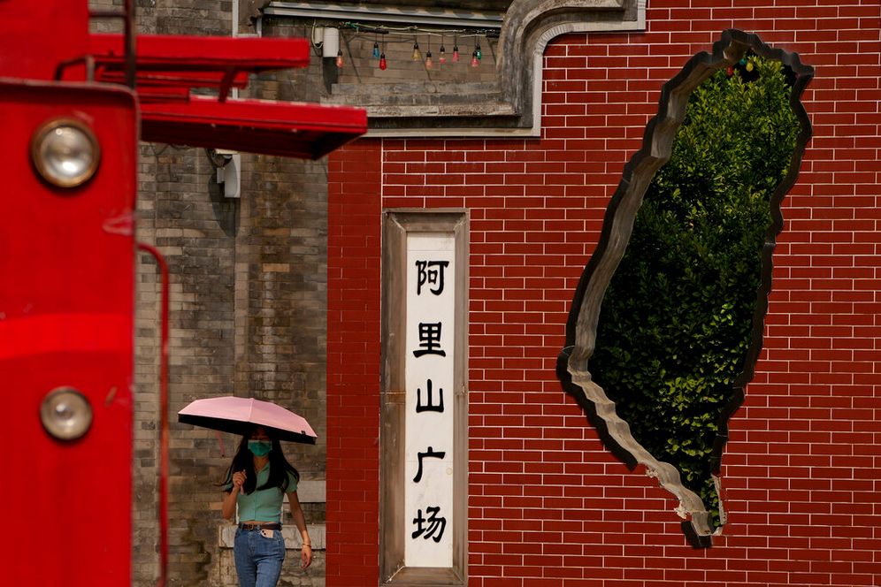 A woman walks by Taiwan's Alishan Square, a commercial area set up by the Taiwanese government near Qianmen Street in Beijing, China, on August 17, 2022.