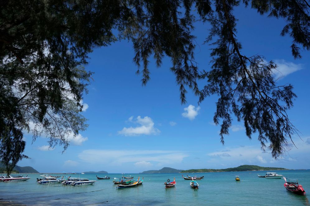 AP Photo/Sakchai Lalit Empty tourist boats anchor off Rawai Beach on Phuket, southern Thailand, Monday, June 28, 2021. Thailand's government will begin the "Phuket Sandbox" scheme to bring the tourists back to Phuket starting July 1. Even though coronavirus numbers are again rising around the rest of Thailand and prompting new lockdown measures, officials say there's too much at stake not to forge ahead with the plan to reopen the island to fully-vaccinated travelers.
