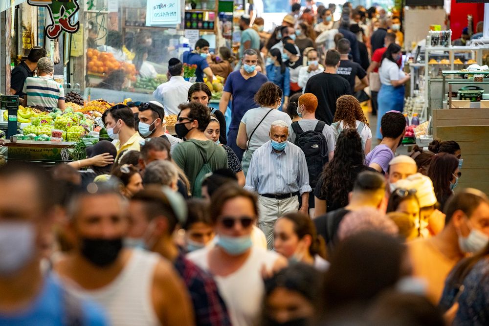People shop for groceries at the Mahane Yehuda Market in Jerusalem, on October 30, 2020.