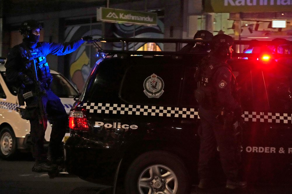 Tactical police leave the scene of a fatal stabbing attack at a mall in Sydney, Australia.