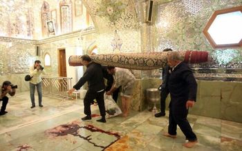 Workers clean up following an deadly armed attack at the Shah Cheragh mausoleum in the Iranian city of Shiraz.
