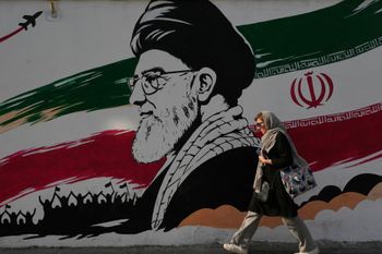 A woman walks past a mural depicting a portrait of the late Iranian Supreme Leader Ayatollah Ali Khamenei, who was killed in the U.S. and Israel strike on Feb. 28, at Azadi (Freedom) street in Tehran, Iran, Wednesday, July 29, 2026. 