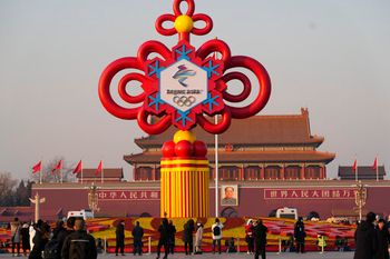 Residents look at a Beijing Winter Olympics decoration on Tiananmen Square in Beijing, China, January 18, 2022.