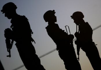 FILE- Palestinian security forces stand guard during a funeral for a high-ranking official in the West Bank refugee camp of Jenin, Wednesday, Sept. 5, 2012.