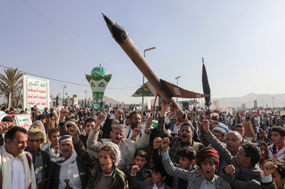 Houthi supporters carry a mock rocket and chant slogans during an anti-Israel rally in Sanaa, Yemen


