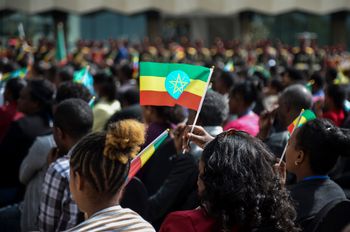 A member of the audience holds a national flag at a ceremony to remember those soldiers who died on the first day of the Tigray conflict, outside the city administration office in Addis Ababa, Ethiopia on Nov. 3, 2022