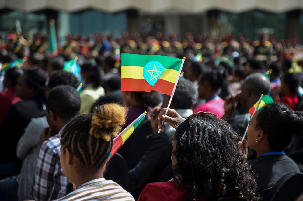 AP Photo A member of the audience holds a national flag at a ceremony to remember those soldiers who died on the first day of the Tigray conflict, outside the city administration office in Addis Ababa, Ethiopia on Nov. 3, 2022