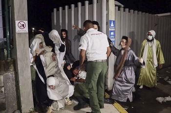 This grab from an AFP video shows members of the Jewish Lev Tahor sect escaping from a detention shelter in Huixtla, Chiapas state, Mexico, on September 29, 2022.
