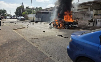 Fire pours out of a car that exploded, killing one, in Afula, northern Israel, on May 26, 2026. 