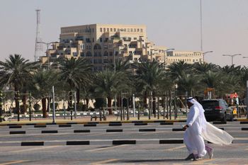 A man walks in a parking lot near a tourist resort by al-Marjan island in the UAE gulf emirate of Ras al-Khaimah on January 26, 2022.