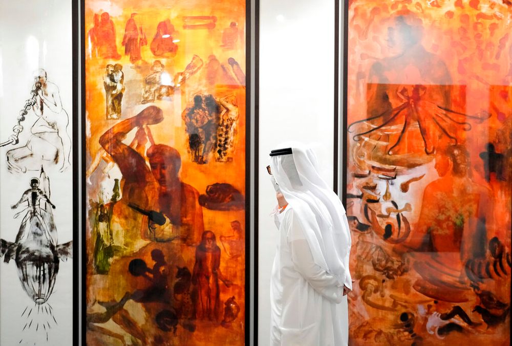 A visitor looks at artwork during Art Dubai in the United Arab Emirates.