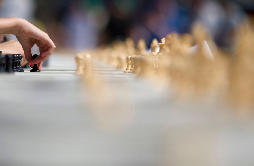 A chess player makes a move.