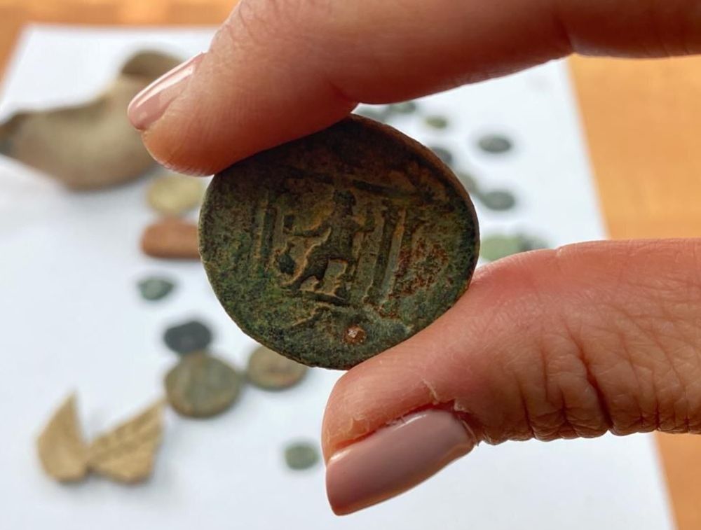 An ancient Hasmonean-era coin is seen among the artifacts seized from the home of an east Jerusalem resident on the last night of Chanukah, on December 5, 2021.