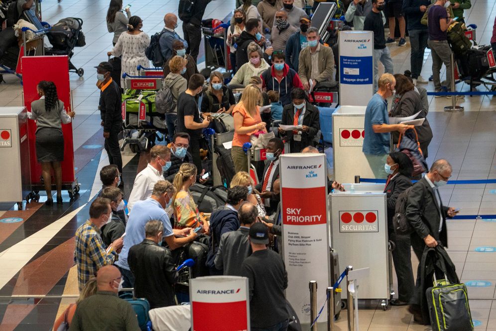 People queue to get on the Air France flight to Paris at OR Tambo's airport in Johannesburg, South Africa, November 26, 2021.