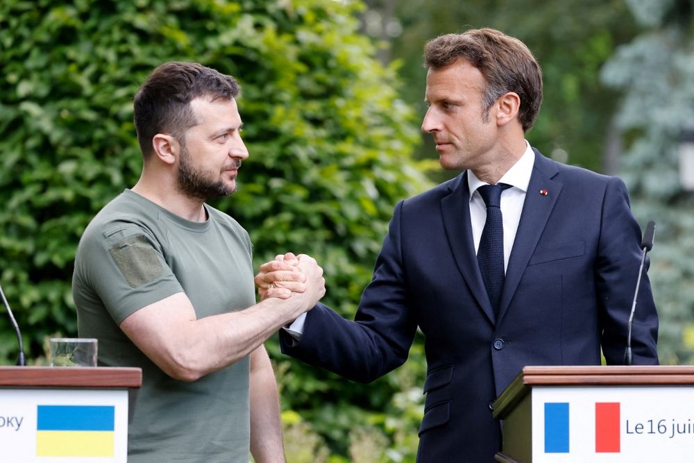 Ukraine's President Volodymyr Zelensky (L) and French President Emmanuel Macron shake hands after giving a press conference in Kyiv, Ukraine, on June 16, 2022.
