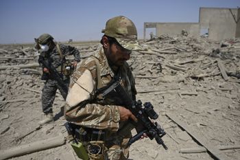 Members of the Taliban Badri 313 military unit walk amid the debris of the destroyed Central Intelligence Agency base northeast of Kabul, Afghanistan, on September 6, 2021 after the US pulled all its troops out of the country.