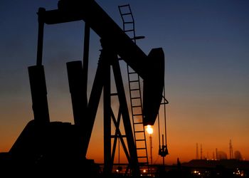 An oil pump works in the desert oil fields of Sakhir, Bahrain.