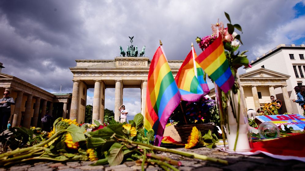 Des fleurs et des drapeaux arc-en-ciel déposés devant la porte de Brandebourg en hommage aux victimes de l'attaque terroriste perpétrée lors de la Pride de Berlin, le lundi 27 juillet 2026
