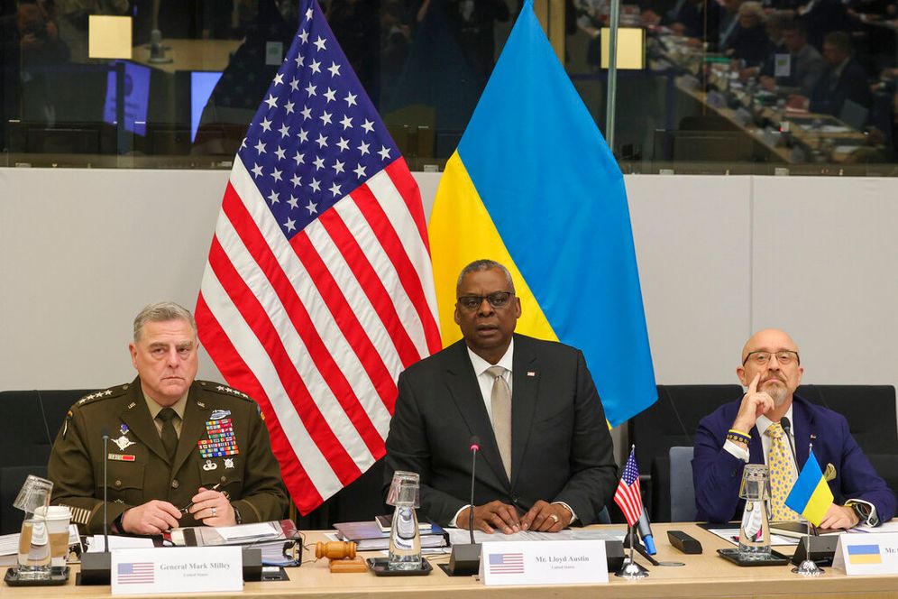 US Secretary of Defense Lloyd Austin (C) flanked by Ukrainian Defense Minister Oleksii Reznikov (R) and Chairman of the Joint Chiefs of Staff General Mark Milley, during a meeting of NATO defense ministers in Brussels, Belgium, on October 12, 2022.