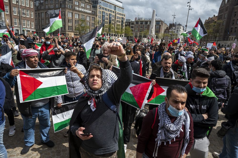 Protesters wave Palestinian flags during a rally to show solidarity with the Palestinians at Dam Square in Amsterdam on May 16, 2021.