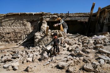 A man cleans up rubble after an earthquake in Gayan village, in Paktika province, Afghanistan, on June 24, 2022.