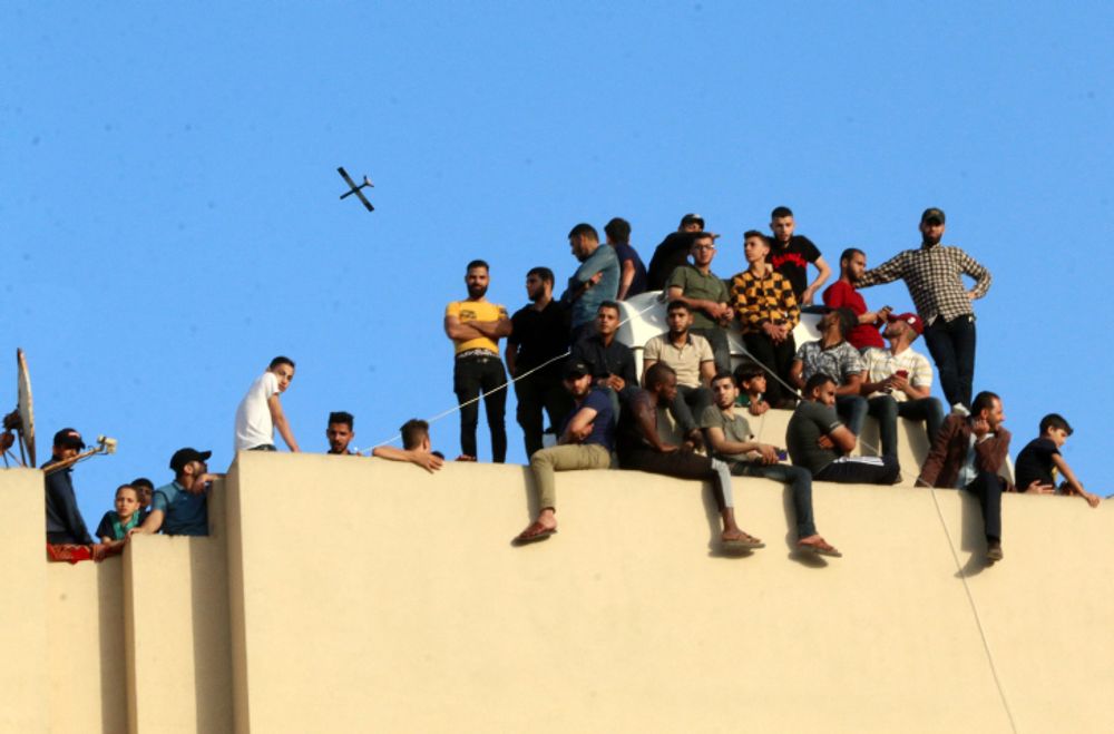 Illustration - a drone seen over members of Al-Qassam Brigades in the Gaza Strip.