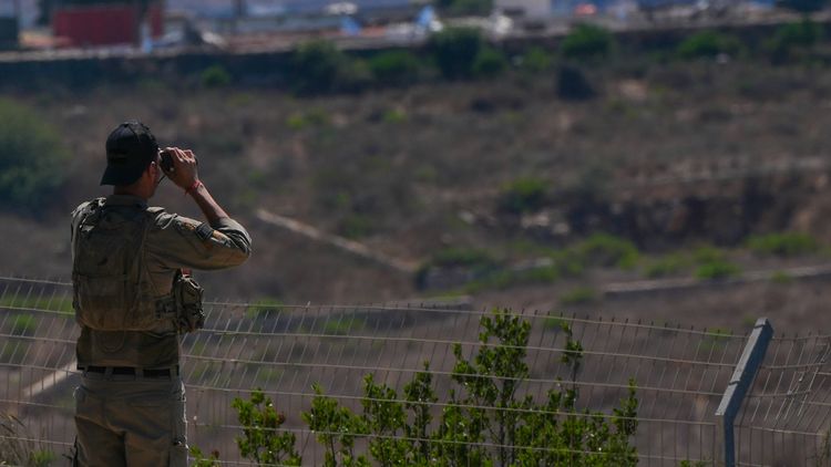 Israeli soldier looks over on south Lebanon, from the Northern Israeli border