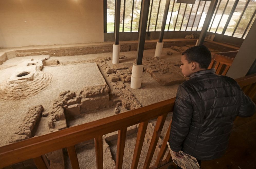 A boy looks at the remnants of a Byzantine church during the inauguration of Mukheitim archaeological site in Jabalia in the northern Gaza Strip on January 24, 2022.