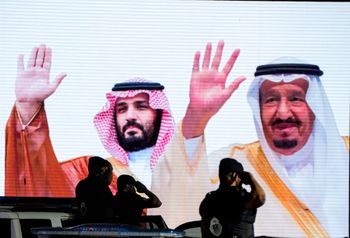 A screen displaying images of Saudi King Salman (R) and Crown Prince Mohammed bin Salman in Mecca, Saudi Arabia.