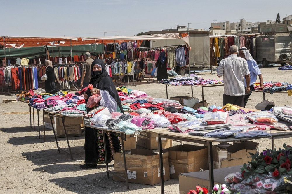 People shop at an open-air market in the Bedouin town of Rahat in Israel's southern Negev region on June 8, 2021.