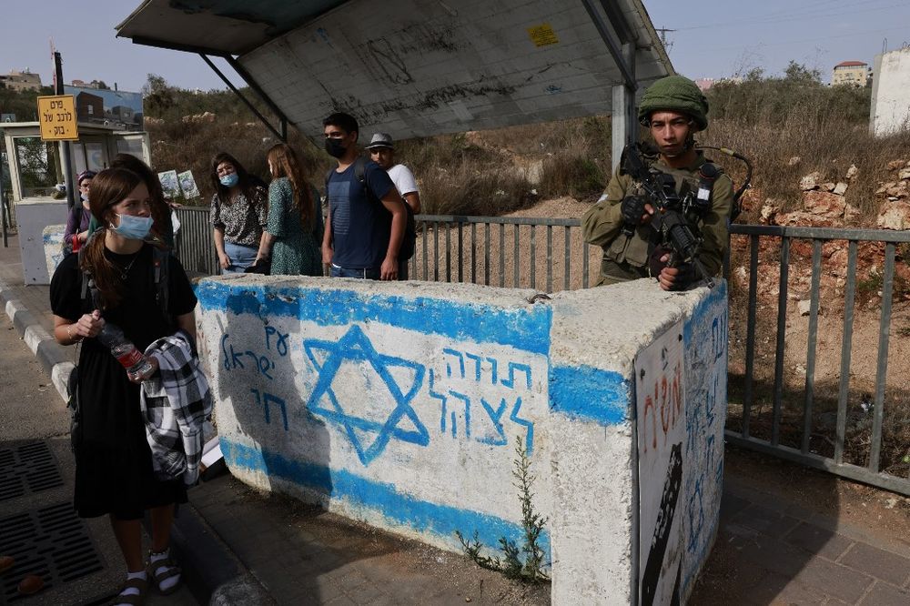An Israeli soldier stands guard near the Jewish settlement of Ariel in the West Bank, on October 14, 2021.