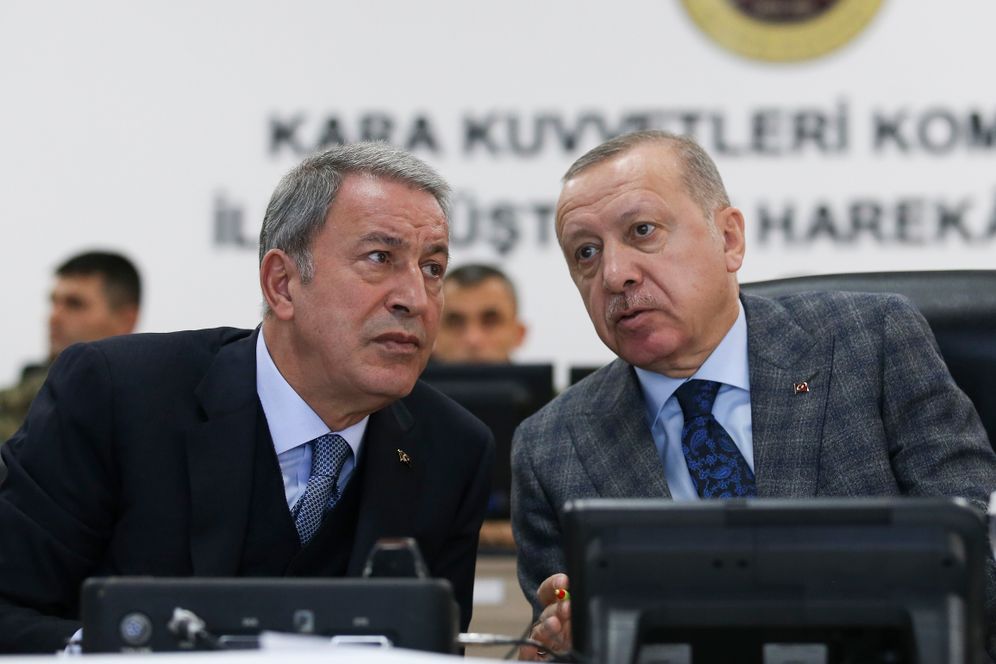 Presidential Press Service via AP, Pool Turkish President Recep Tayyip Erdogan, right, speaks with Defense Minister Hulusi Akar as they visit a military coordination center set up for Turkey's Syria operation, in Sanliurfa, southeastern Turkey, Sunday, Nov. 3, 2019.