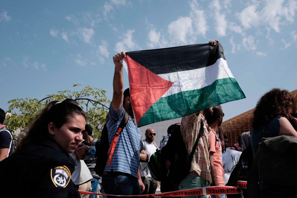 Students holding a Palestinian national flag at Tel Aviv University in Israel.