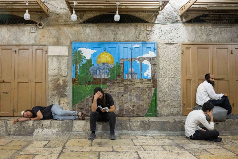 Jews pray at the entrance to the Temple Mount compound in Jerusalem's Old City, during Tisha B'Av.