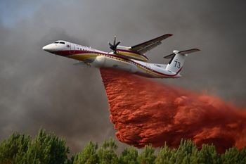 AP Photo/Emma Da Silva A De Havilland Canada Dash 8-400 releases fire retardant as it flies over a forest near Blagon, during wildfires in southwestern France, Wednesday, July 29, 2026.