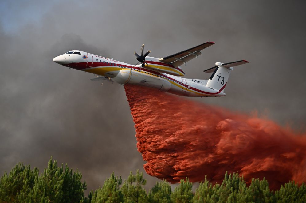 AP Photo/Emma Da Silva A De Havilland Canada Dash 8-400 releases fire retardant as it flies over a forest near Blagon, during wildfires in southwestern France, Wednesday, July 29, 2026.
