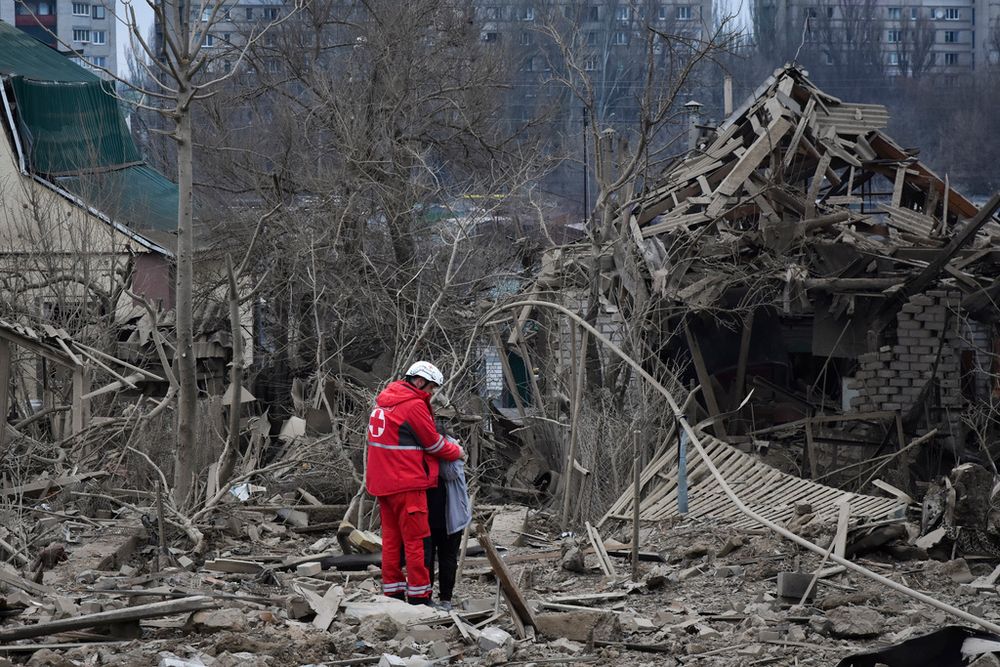 A medical worker comforts a woman at the site of Russia's air attack, in Zaporizhzhia, Ukraine, Friday, March 22, 2024.