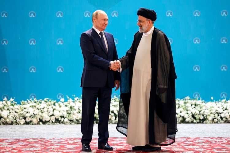 Russian President Vladimir Putin (L) and Iranian President Ebrahim Raisi shake hands in Tehran, Iran, on July 19, 2022.