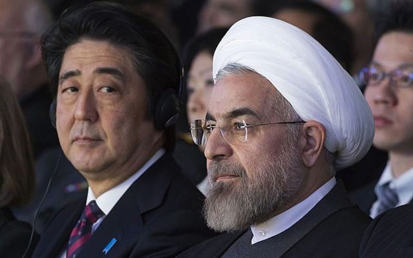 In this Jan. 22, 2014 file photo, Japanese Prime Minister Shinzo Abe, left, and Iranian President Hassan Rouhani, attend a session of the World Economic Forum in Davos, Switzerland