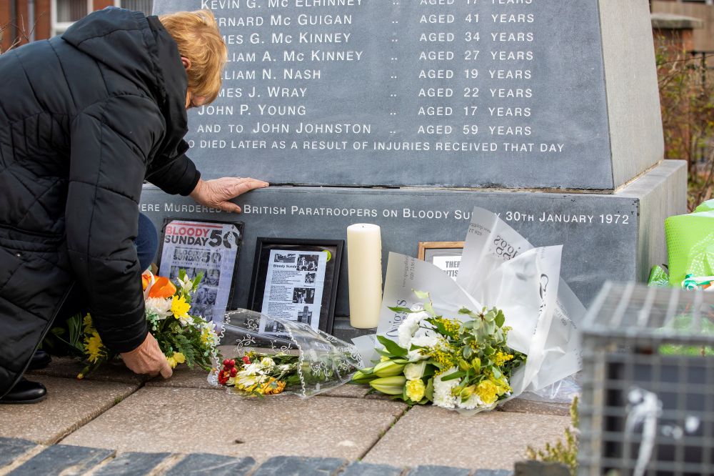 Flowers are placed at a memorial engraved with the names of those who died during the 1972 Bloody Sunday killings, in the Bogside area of ​​Londonderry, Northern Ireland on January 29, 2022.