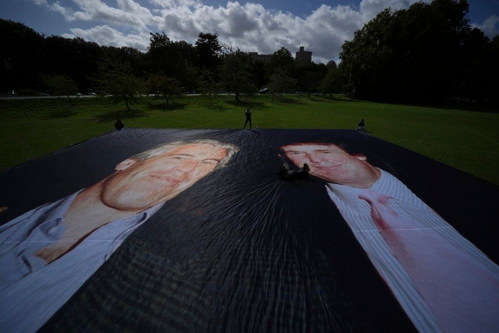 Activist from the protest group Everyone Hates Elon put up a poster of President Donald Trump and Jeffrey Epstein, ahead of the state visit by US President Donald Trump, in Windsor, England, Monday, Sept. 15, 2025. 