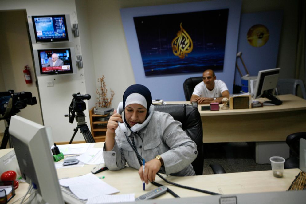 An employee seen working at Al-Jazeera's offices in Ramallah, the West Bank