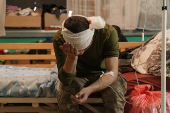 A wounded soldier waits for treatment in a room of the military hospital in Zaporizhzhya, Ukraine, on March 31, 2022.